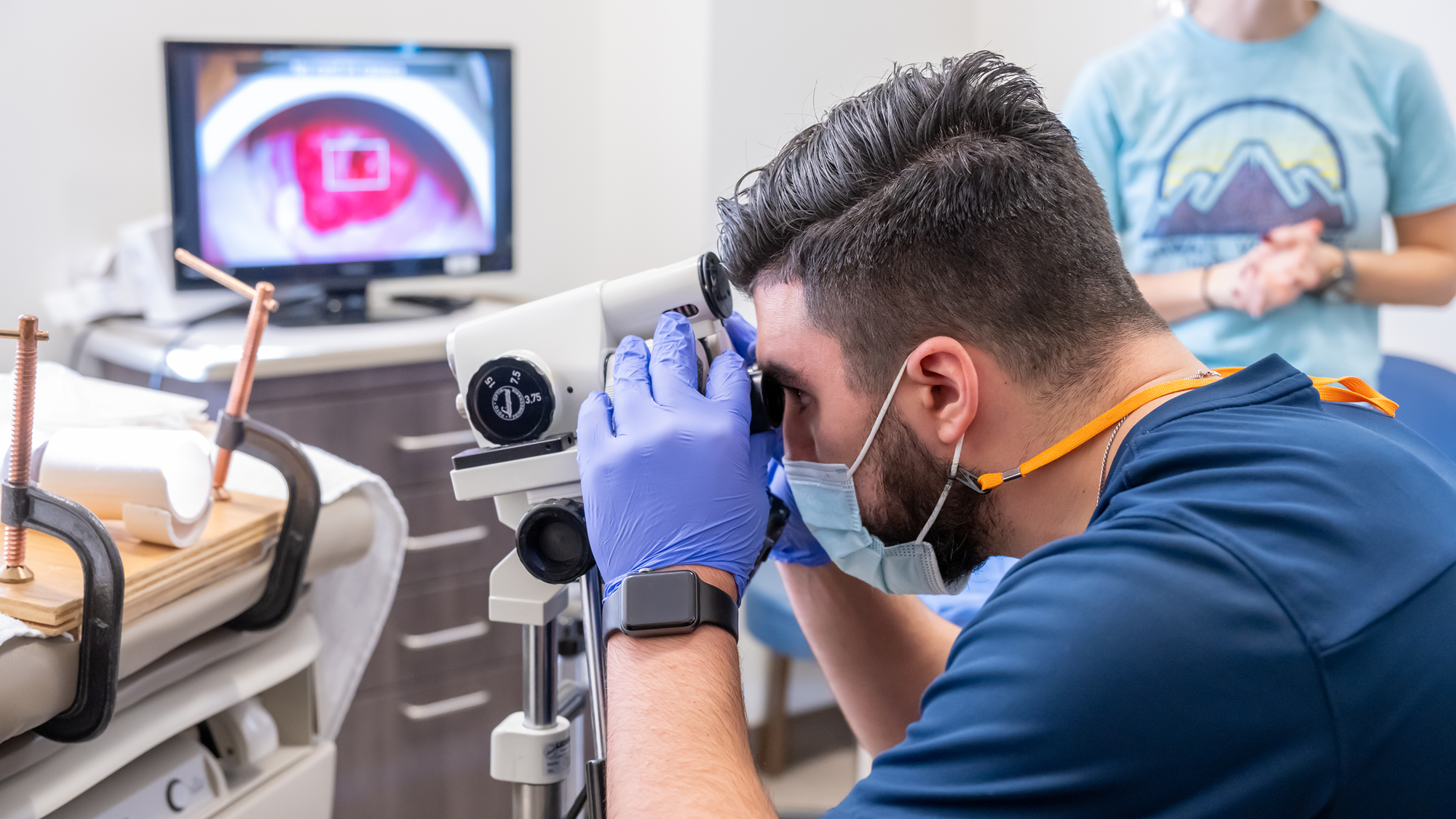 Male resident uses optical exam equipment