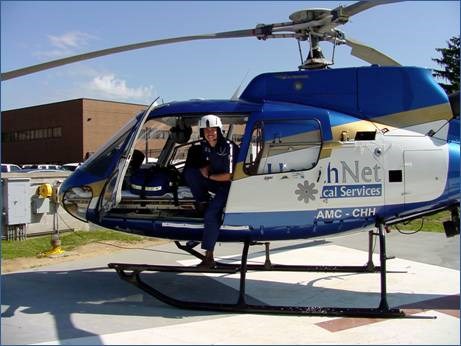 Health Net helicopter with a pilot emerging