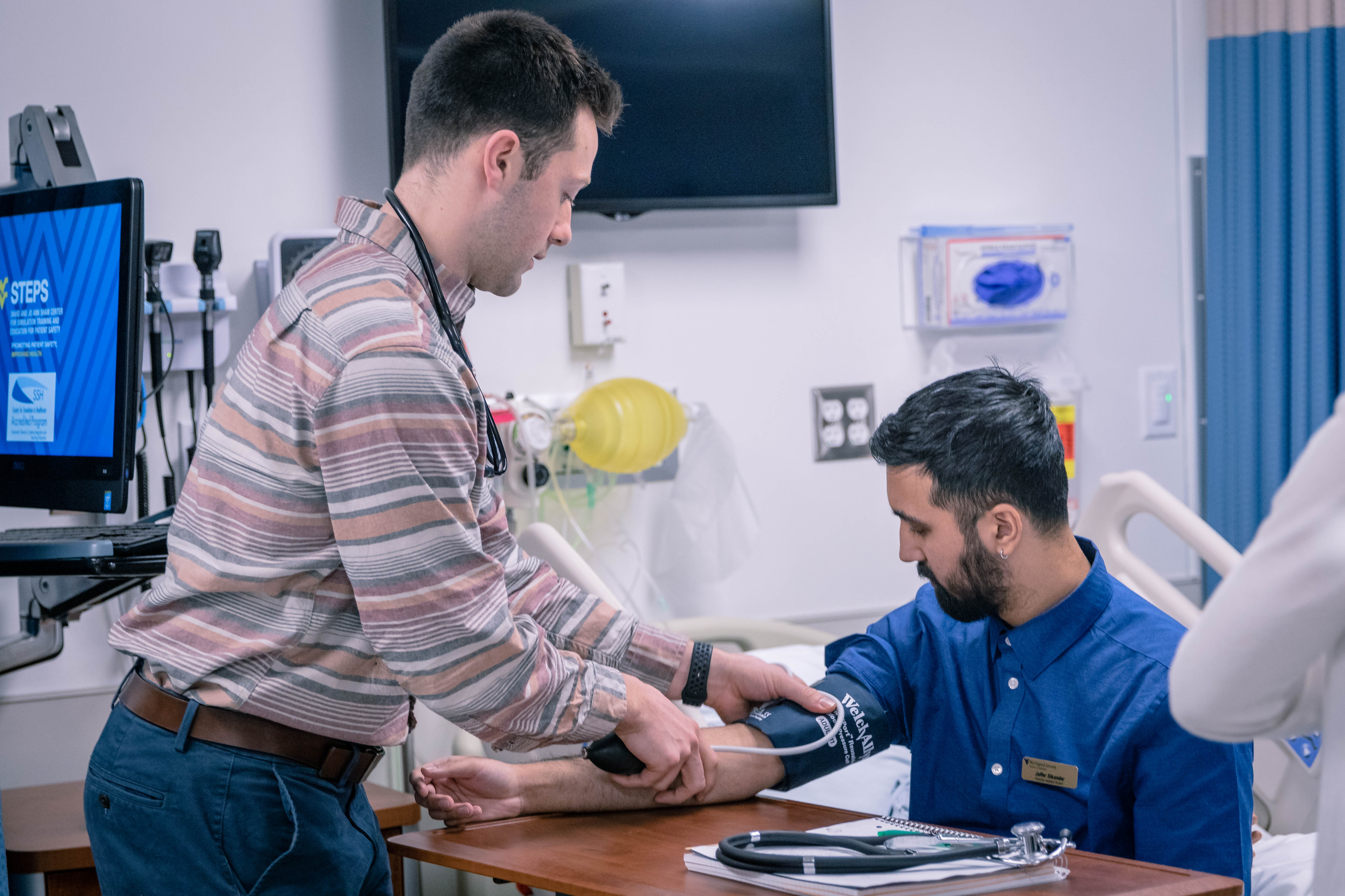 physician assistant student doing blood pressure check