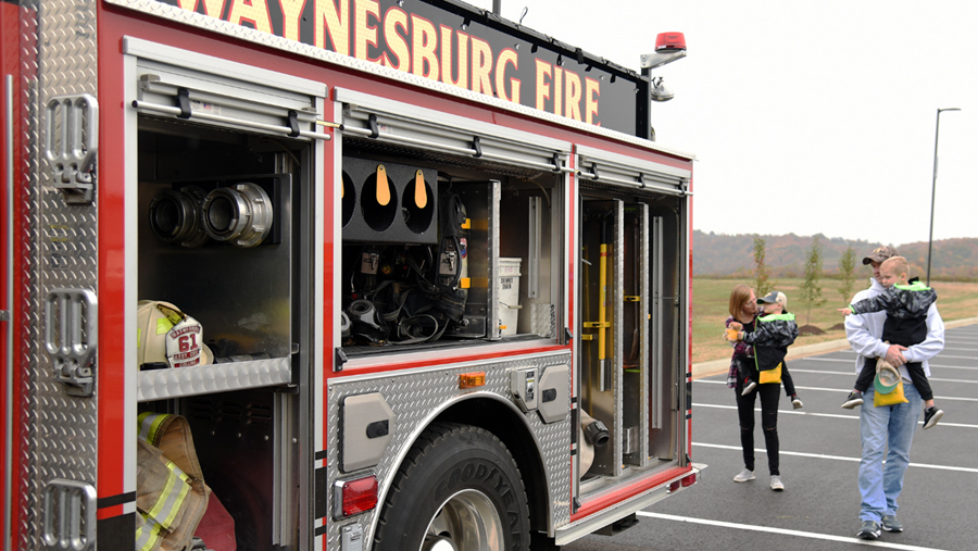 Kari Roupe, Senior Physician Recruiter and family check out a firetruck during Waynesburg's Open House.