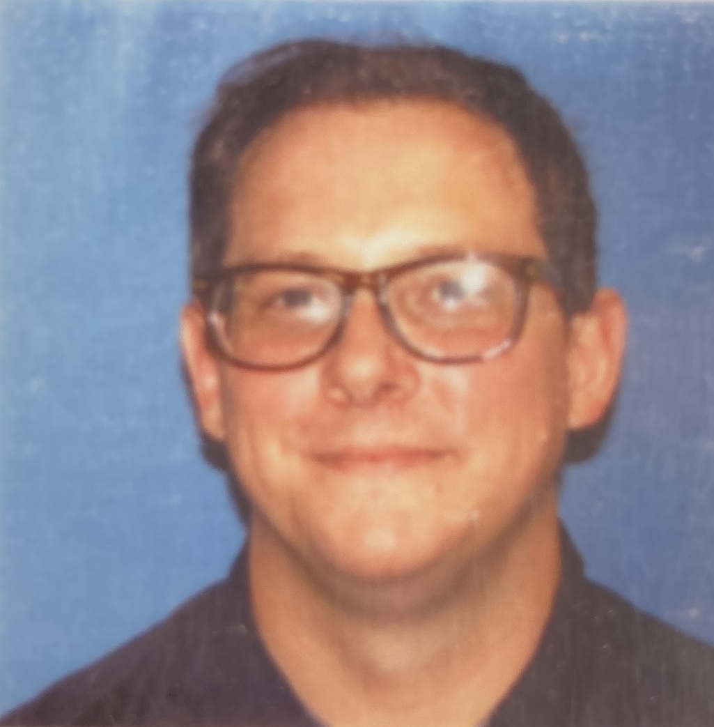 A headshot photo of Scott Rhodes.