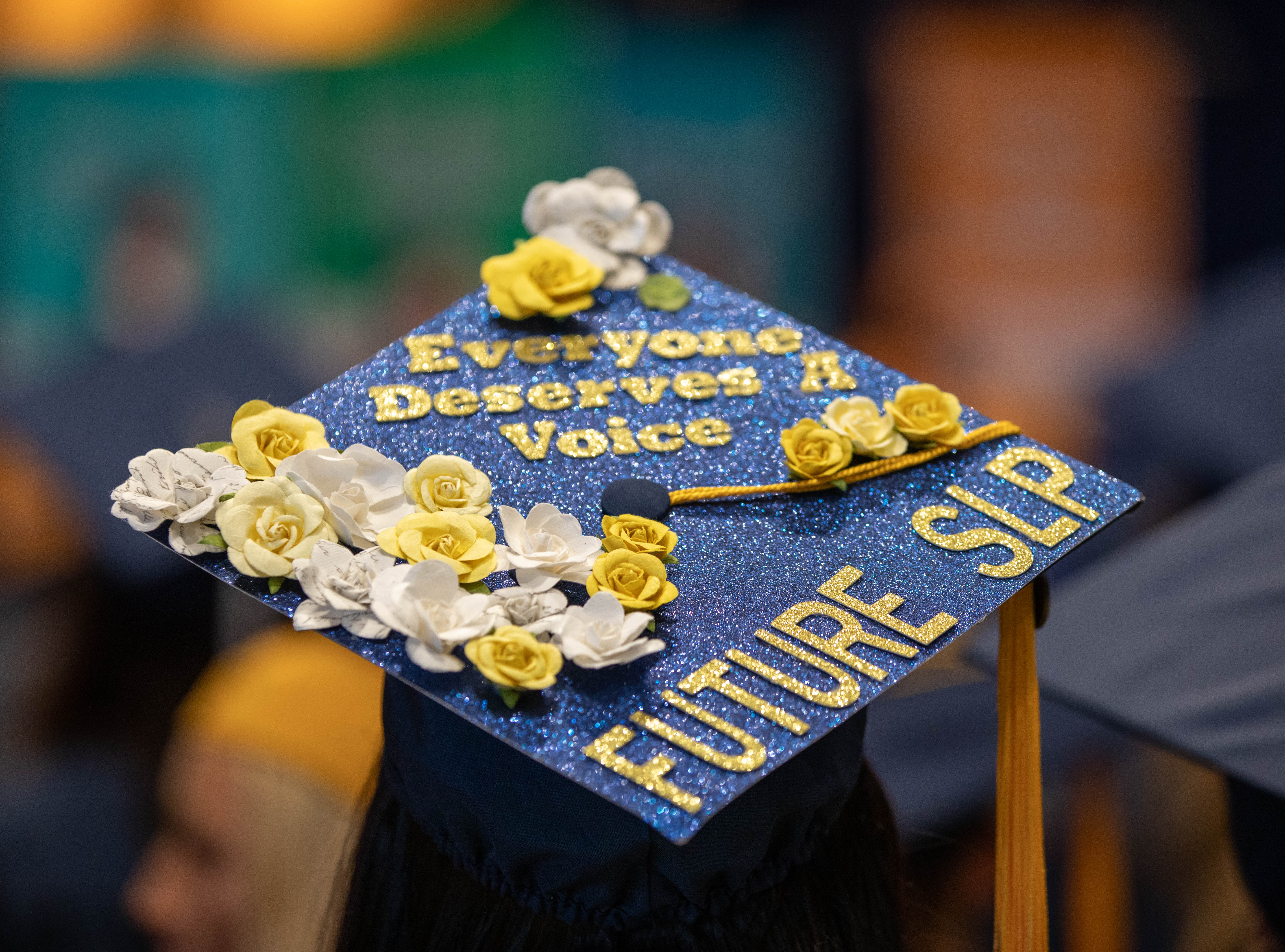 Graduation cap from spring commencement 2022 that reads "everyone deserves a voice: future SLP"