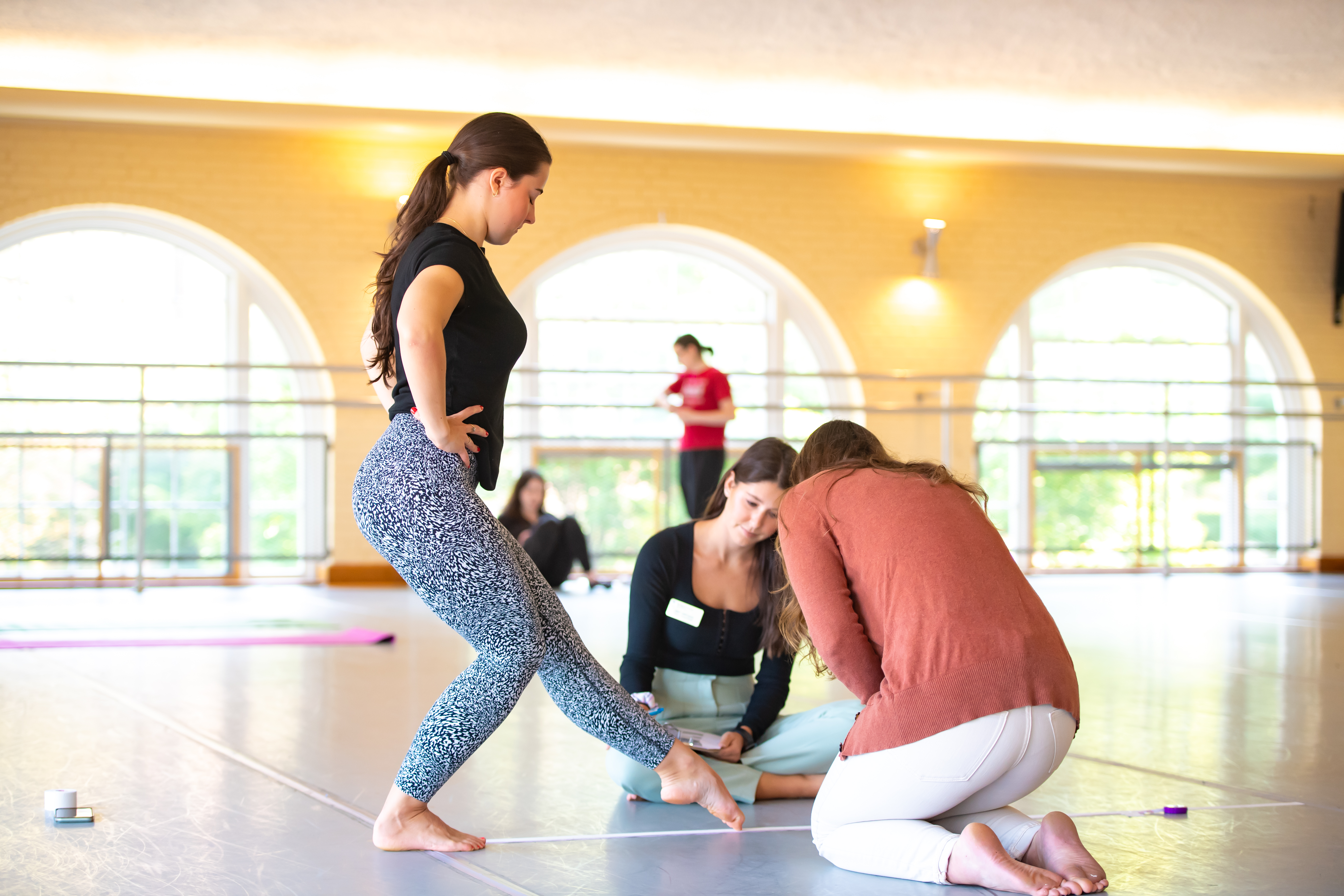 Students perform dancer assessments in the WVU Dance Studio