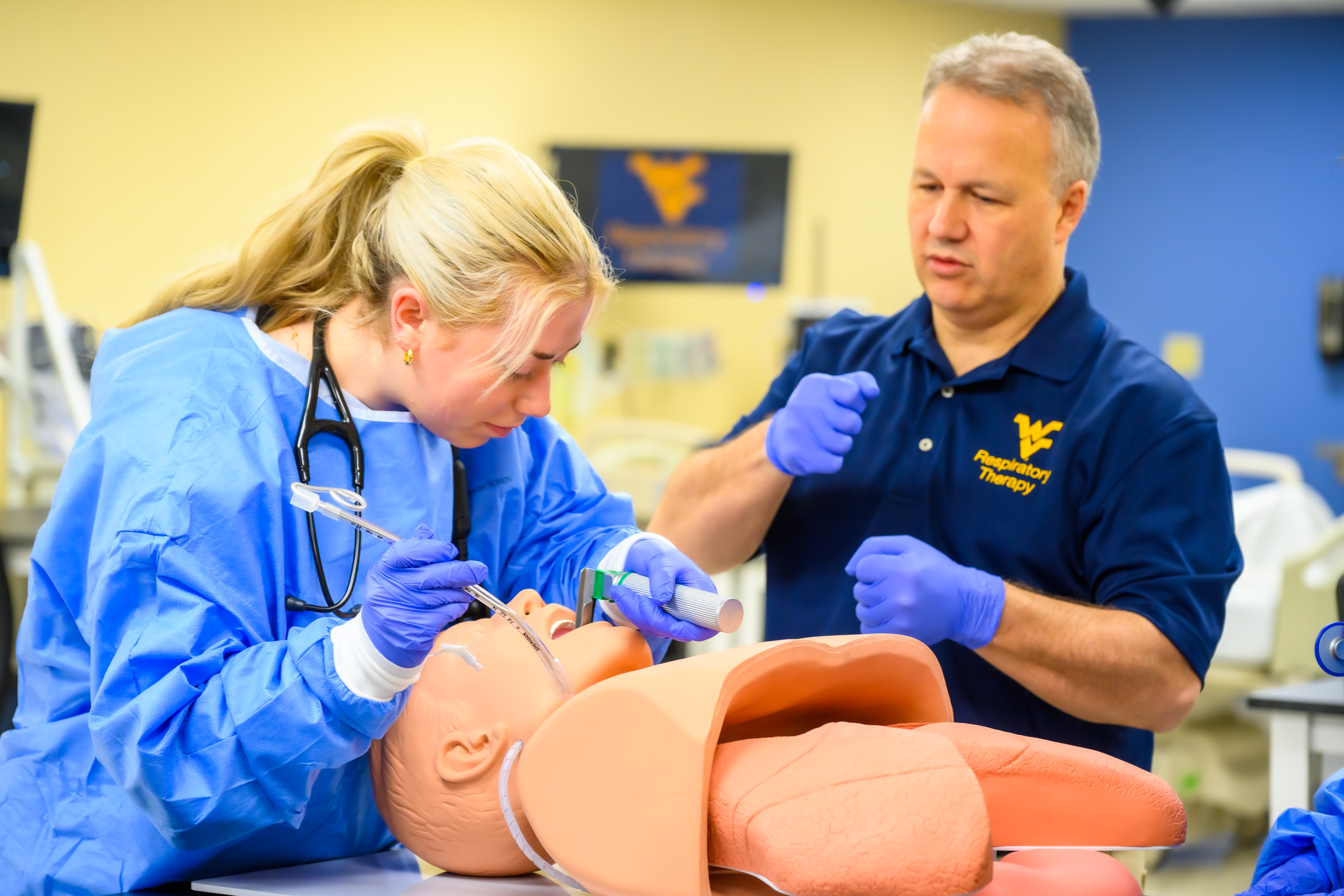 Program Director Mike Mehall demonstrates intubation technique to student