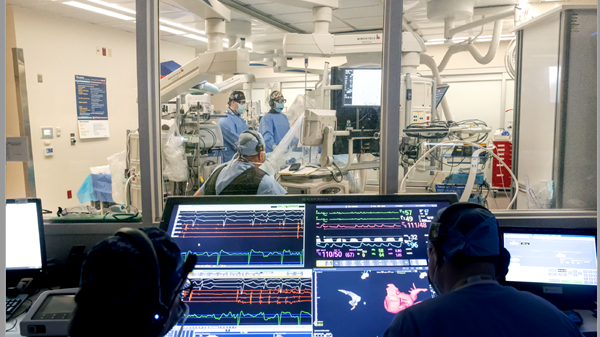 Team of surgeons in operating room viewing procedure