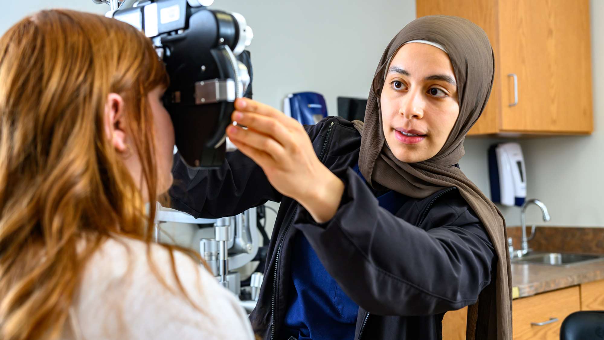 WVU ophthalmology resident performs eye exam on patient