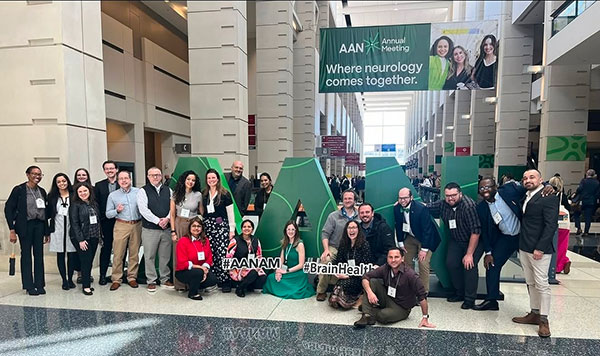 Residents gathering at the AAN Annual meeting.  They are in the main hall gathering around the large three dimensional letters staged for the event in different poses.